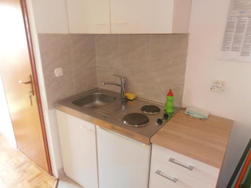 a small kitchen with a sink and a counter at Vala in Božava
