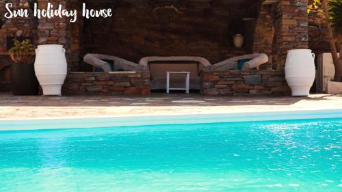 a swimming pool in front of a house at Sun Holiday House in Pisses