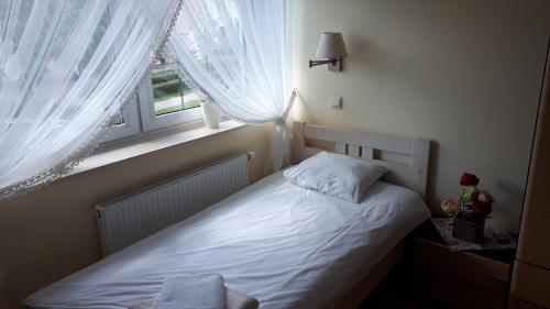 Ένα ή περισσότερα κρεβάτια σε δωμάτιο στο Hotel Finezja