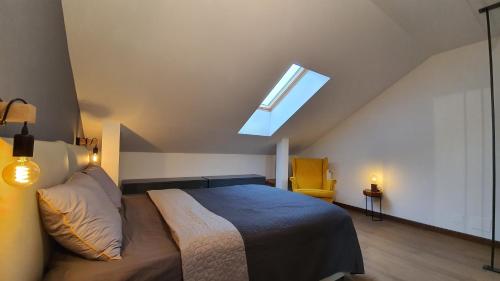a bedroom with a bed and a skylight at Marmot apartment up & down in Poiana Brasov