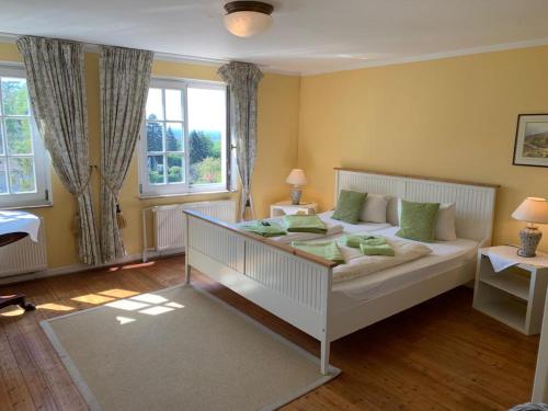 a bedroom with a white bed and a window at Hotel Drei Kronen in Tecklenburg