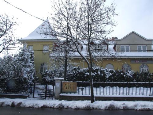 a yellow house with a sign that says ark at Art Guesthouse in Budapest