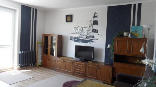 a living room with a tv on a wall at FitoSfera Inez in Jastarnia