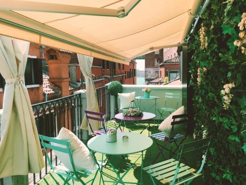 a patio with tables and chairs on a balcony at Aquamare, boutique b&b in Venice