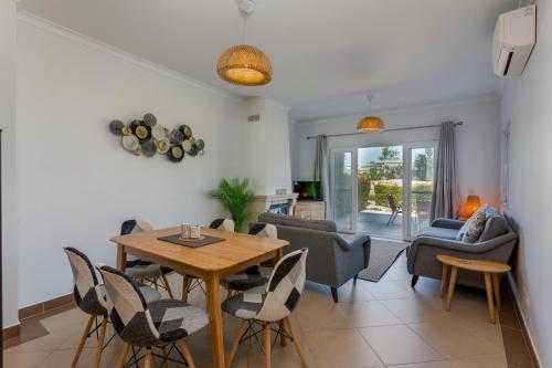 a living room with a table and chairs at Casa Joana at Opomar by Cara Rentals in Cabanas de Tavira