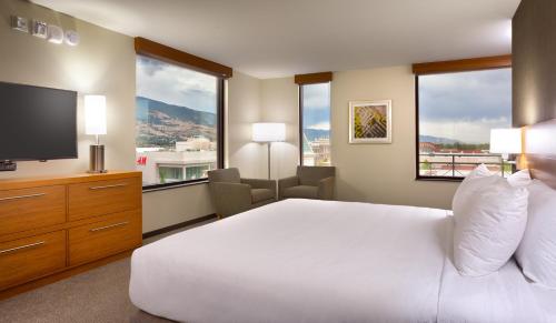 a bedroom with a white bed and a television at Hyatt Place Salt Lake City Farmington Station Park in Farmington