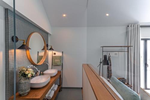 a bathroom with two sinks and a mirror at Quinta da Salada - Turismo Rural in Lamego