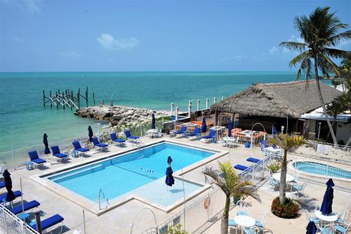 a resort with a swimming pool next to the ocean at Glunz Ocean Beach Hotel and Resort in Marathon