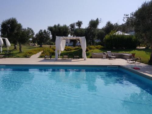 a swimming pool with a tent and an outdoor wedding at Masseria Montevergine in Otranto