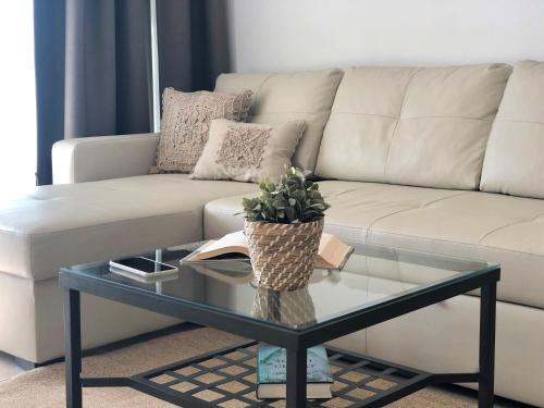 a living room with a couch and a glass table at Mediterraneo Sitges in Sitges