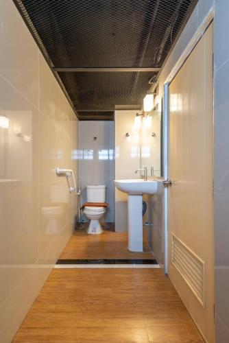 a bathroom with a sink and a toilet at Infinite Hotel in Bangkok