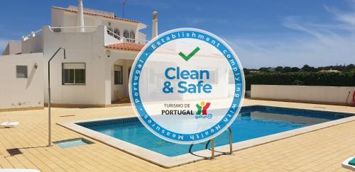 a sign for a clean and safe sign in front of a swimming pool at Vila Ricardo by Sunny Deluxe in Albufeira
