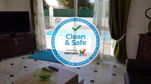 a sign that says clean and safe in a living room at Villa Golfinho by Sunny Deluxe in Albufeira