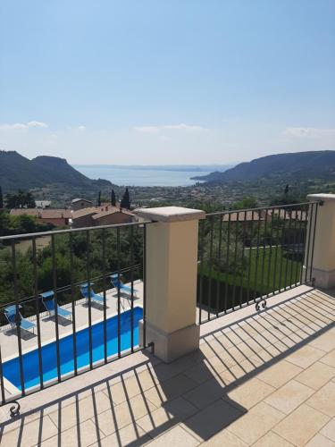 a balcony with a view of a swimming pool at Villa Benvenuto in Costermano sul Garda