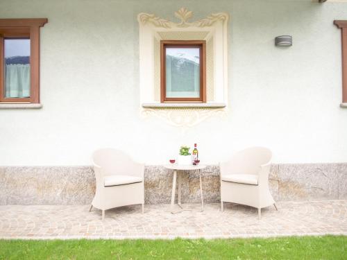 a table and chairs in front of a house at Residence Pedranzini in Bormio