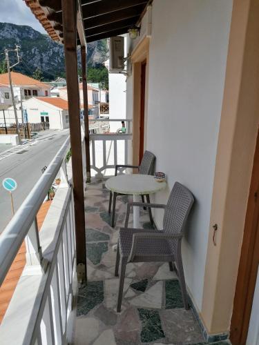 a patio with chairs and a table on a balcony at Lefteris Rooms in Kokkari