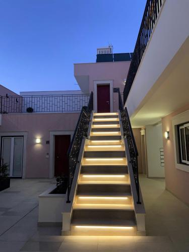 a set of stairs leading to a building with lights at Cardeal Suites & Apartments in Faro