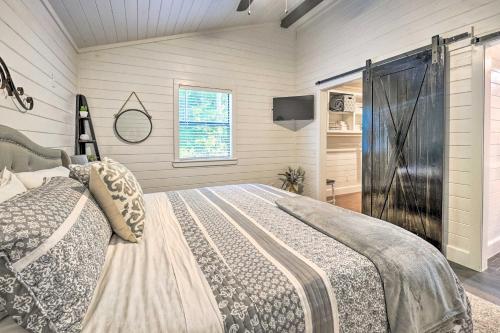 a bedroom with a bed and a television in it at Cozy Chic Broken Bow Cabin with Fire Pit and Grill! in Broken Bow