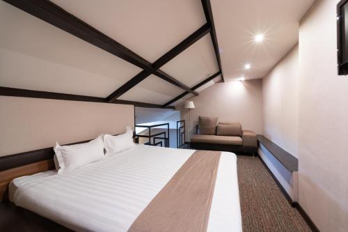 Ένα ή περισσότερα κρεβάτια σε δωμάτιο στο Bass Boutique Hotel