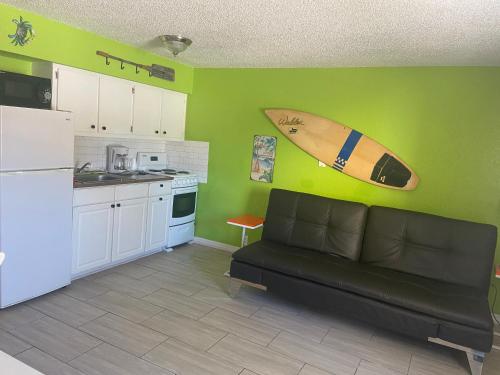 a living room with a couch and a refrigerator at Hideaway Village in Fort Myers Beach