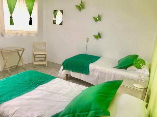 Postel nebo postele na pokoji v ubytování Hostal Tlaquepaque