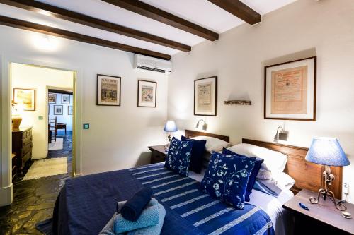 a bedroom with a large bed with blue pillows at Quinta da Dourada in Portalegre