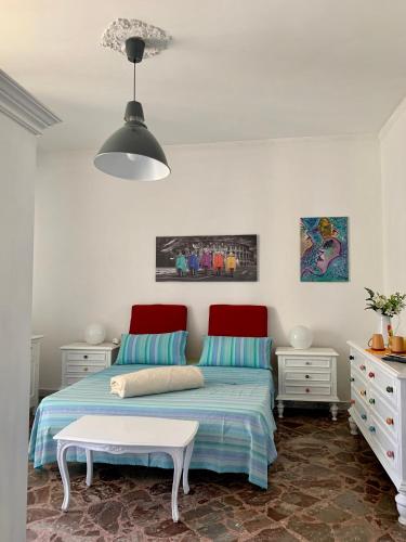 a bedroom with a bed with a red headboard at Larala' in Lecce