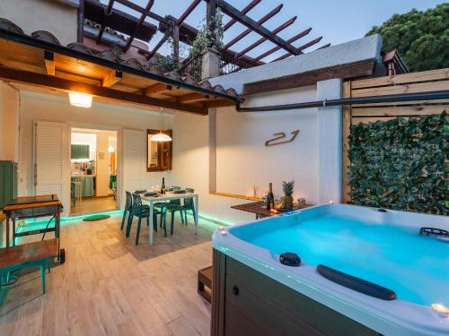 a pool in a backyard with a table and chairs at Sardinia SPA Apartment in Geremèas