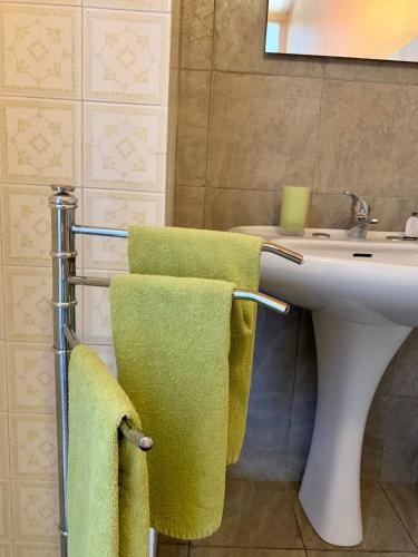 a bathroom with green towels and a sink at Larala' in Lecce