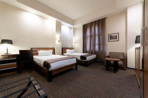 Ένα ή περισσότερα κρεβάτια σε δωμάτιο στο Bass Boutique Hotel