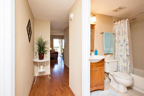 a bathroom with a toilet and a sink at Ocean Watch Condo Unit #105 in Ormond Beach
