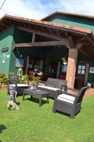 a dog laying on the grass in front of a house at El Rincón del Oteru in Llanes