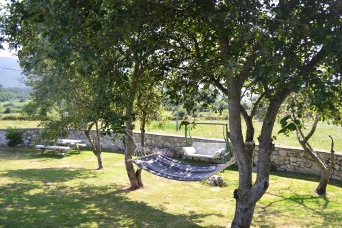 a hammock hanging between two trees in a yard at El Rincón del Oteru in Llanes
