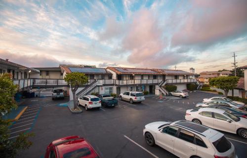 a parking lot with cars parked in front of a building at Days Inn by Wyndham Monterey Downtown in Monterey