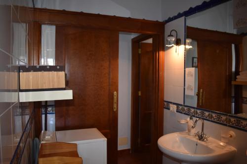 a bathroom with a sink and a toilet and a mirror at Casa Rosa in Tijarafe