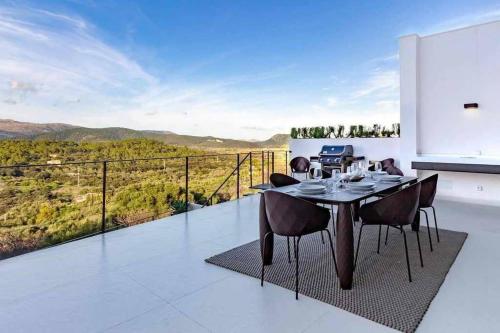 a dining room with a table and chairs on a balcony at Montblau in Búger