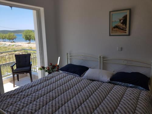 a bedroom with a bed with a view of the ocean at MAREMARI VILLA in Ayía Marína