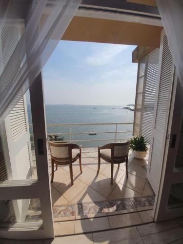 a balcony with a view of the ocean at Pousada Pedra das Tartarugas in São Francisco do Sul
