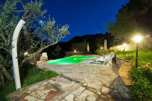 a swimming pool in a yard at night at Agriturismo Coldipietra in Cessapalombo