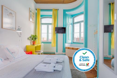 a bedroom with a bed with two towels on it at C&O Guest House Lisbon in Lisbon