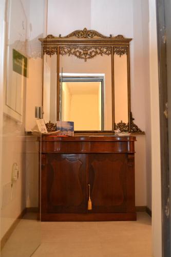a bathroom with a wooden vanity and a mirror at Monaciello in Naples
