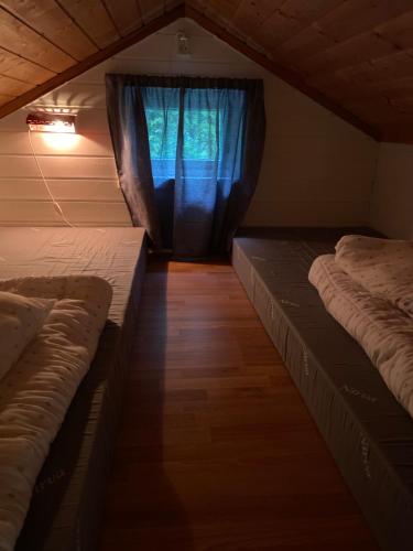 a bedroom with a bed and a window at Nygård Camping in Hjelle