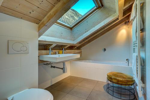 a bathroom with a sink and a toilet and a skylight at Villa Mont Blanc in Chamonix-Mont-Blanc
