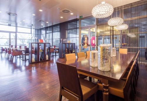 a dining room with a long table and chairs at Best Western Premier BHR Treviso Hotel in Quinto di Treviso