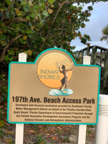 a sign for a beach access park with a person on a surfboard at Sea Club Condo #37 in Clearwater Beach