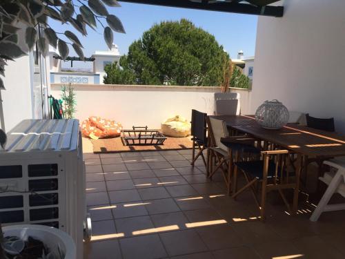 a patio with a table and chairs and a fence at Garden Villa, Cosy House by the sea in Praia Verde