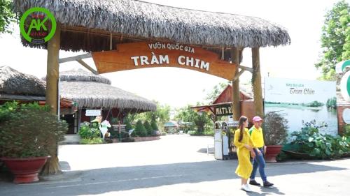 two women walking in front of a train station at Motel Anh Kiệt - Vườn Quốc Gia Tràm Chim in Tràm Chim