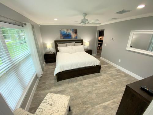 a bedroom with a bed and a large window at Mickeys Pearl - Phenomenal 7BR with 4 Master Suites Privacy Pool & Hot Tub Gas BBQ - 2 miles to Disney in Orlando