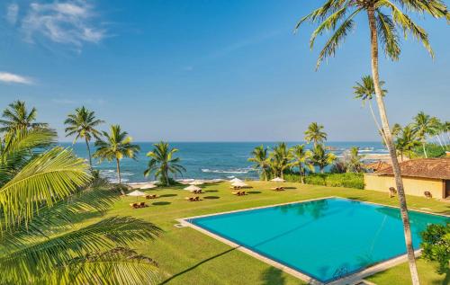 an overhead view of a swimming pool and the ocean at Jetwing Lighthouse in Galle