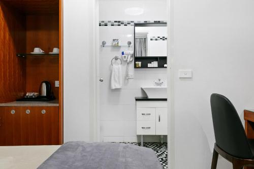 a small kitchen with a sink and a counter at Comfort Inn & Suites Burwood in Sydney